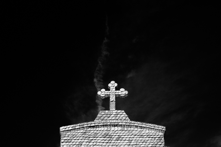 Black and white church with red filter