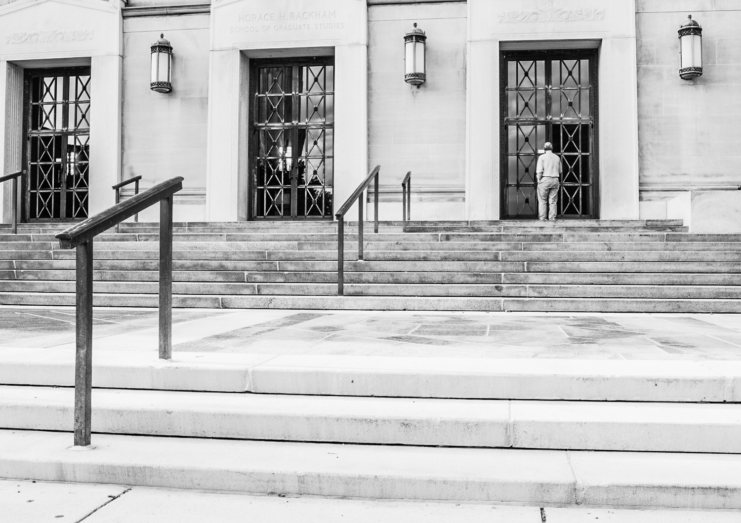 man walking through door street photography camera